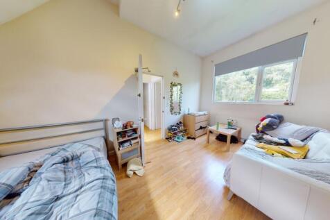 Bright and spacious master bedroom featuring a ...