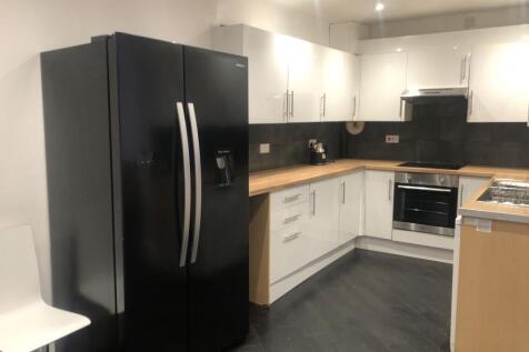 Modern kitchen featuring sleek black and white ...