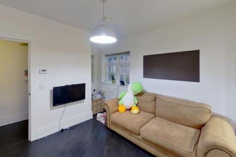 A cozy and neat living room featuring a comfort...