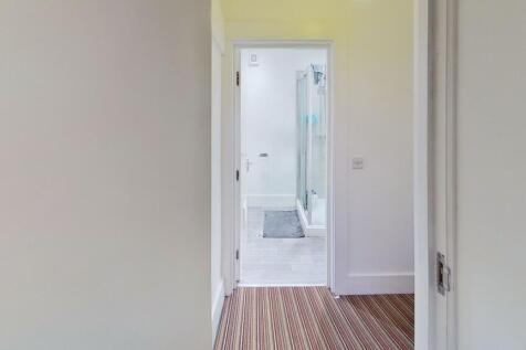 A clean and bright hallway featuring light-colo...