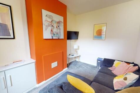 A cozy living room with a stylish orange firepl...