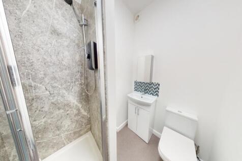 Bright and modern bathroom featuring a spacious...