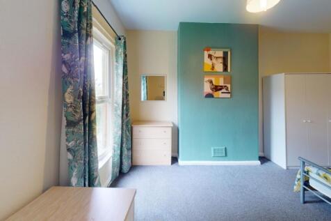 A bright and tidy single bedroom featuring a la...