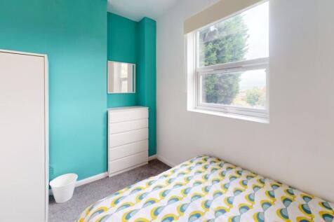 A bright and tidy single bedroom featuring a co...