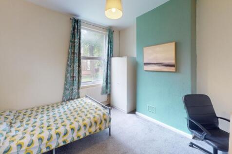 Bright and cozy single bedroom featuring a comf...