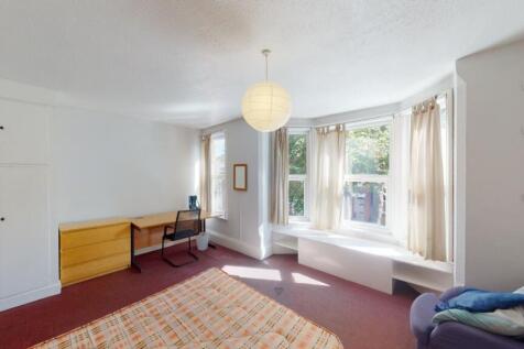 Bright and spacious master bedroom featuring a ...