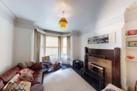 A charming living room featuring a cozy firepla...