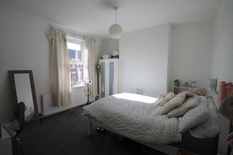 Bright and airy master bedroom featuring a cozy...