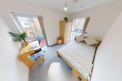 Bright and airy master bedroom featuring a doub...