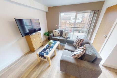 Bright and modern living room featuring a comfo...