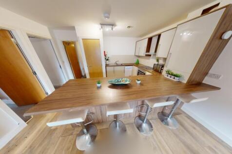 A modern kitchen featuring a spacious wooden co...