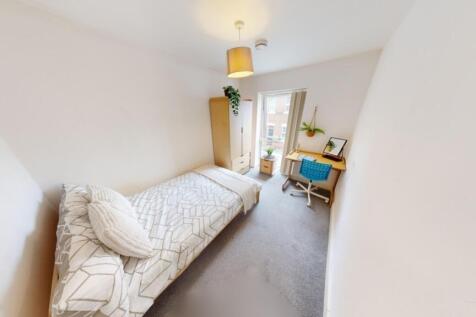 Bright and cozy single bedroom featuring a comf...
