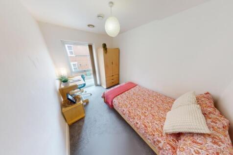 A bright and tidy single bedroom featuring a co...