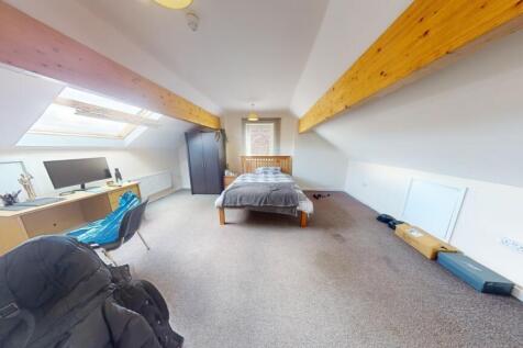 A spacious and bright master bedroom featuring ...