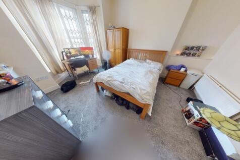 A bright and spacious master bedroom featuring ...