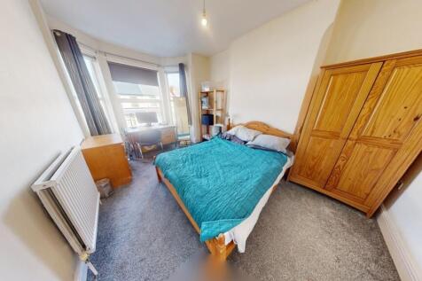 Bright and cozy double bedroom featuring a comf...