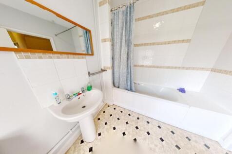 Bright and clean bathroom featuring a full-size...