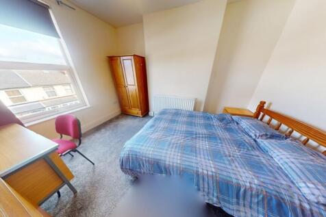 A bright and inviting double bedroom featuring ...