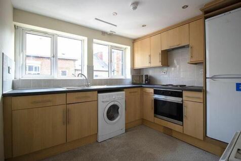 Spacious and modern kitchen featuring ample cab...