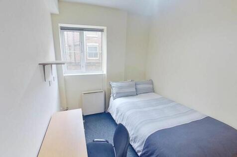 Cozy double bedroom featuring a comfortable bed...