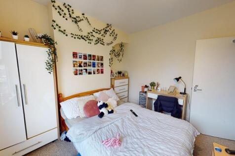 A cozy and inviting master bedroom featuring a ...