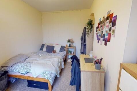 A cozy double bedroom featuring a neatly made b...