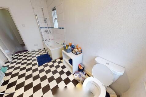 Bright and clean bathroom featuring a classic b...