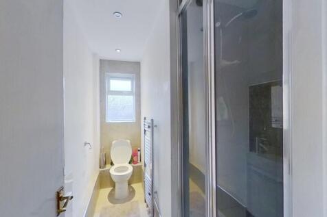 A clean and well-maintained narrow toilet room ...