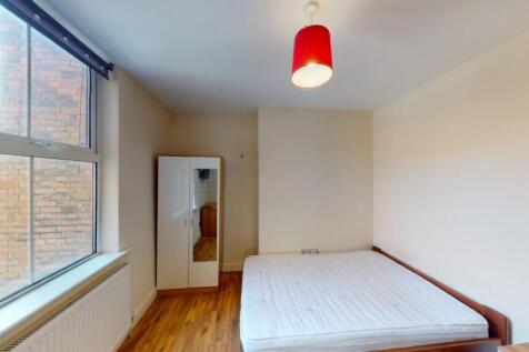 Bright and simple double bedroom featuring a la...