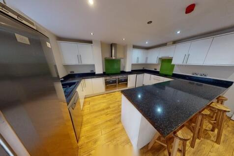 A modern, well-lit kitchen featuring a spacious...