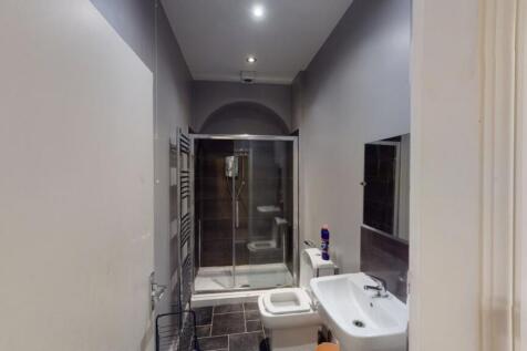 A modern bathroom featuring a large walk-in sho...