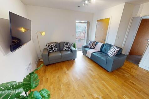A bright and welcoming living room featuring tw...