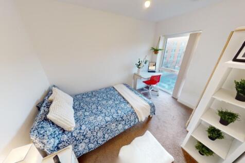 A neat and inviting single bedroom featuring a ...