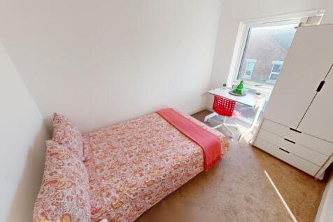 A bright and tidy single bedroom featuring a co...