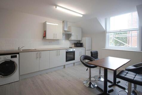 Modern kitchen featuring ample storage, sleek a...