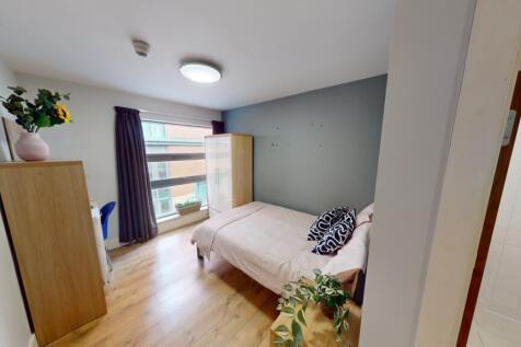 A bright and welcoming master bedroom featuring...