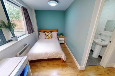 A bright and clean single toilet room featuring...