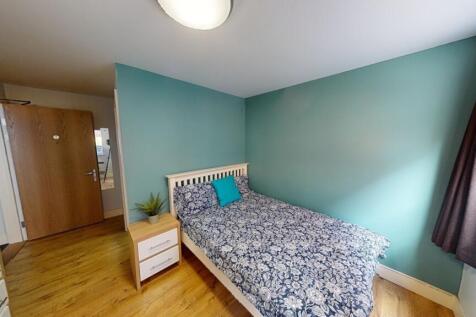 A clean and tidy single toilet room with wooden...