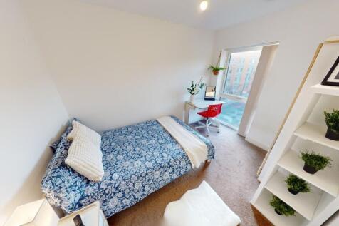 Bright and tidy bedroom featuring a comfortable...