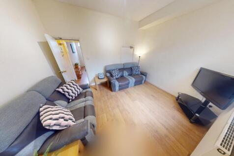 A bright and welcoming living room featuring mo...