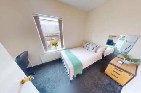 A bright and cozy double bedroom featuring a co...