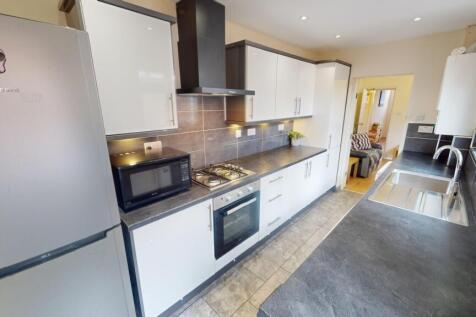 Bright and modern kitchen featuring sleek white...