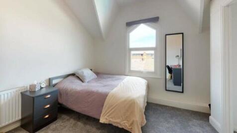 A cozy double bedroom featuring a comfortable b...