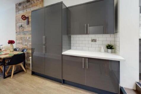 Modern kitchen featuring sleek grey cabinets wi...