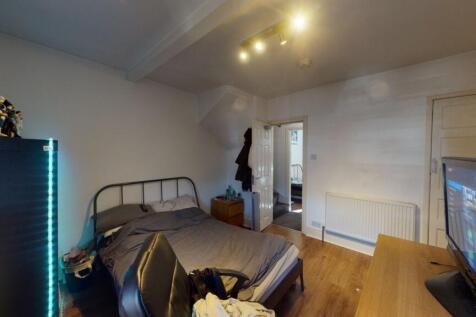 A spacious master bedroom featuring a double be...