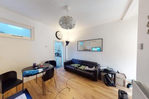 A contemporary living room with wooden flooring...