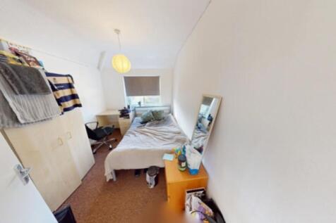 A cozy double bedroom with natural light and a ...