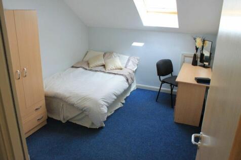 Cozy double bedroom featuring a comfortable bed...