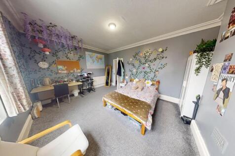 A bright and spacious master bedroom featuring ...