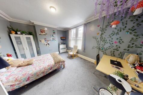 A spacious and inviting master bedroom featurin...